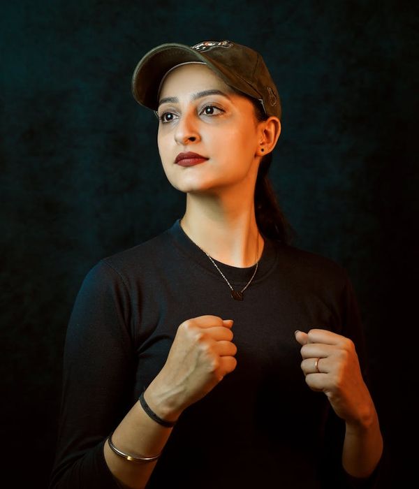 Woman in a dynamic pose feeling energetic against a dark background with lime accents.
